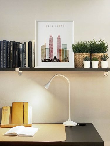 Framed artwork of Kuala Lumpur featuring iconic buildings and a skyline silhouette.