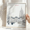 Framed artwork of Albany featuring a stylized depiction of a cityscape with buildings and trees.