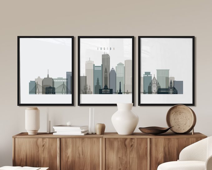 Three framed prints of Boston's skyline featuring various buildings and structures in muted colors.