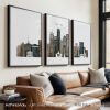 Three framed art prints depicting a cityscape of Boston with various buildings and skyline elements.