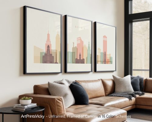 Three framed cityscape art prints displayed on a wall with decorative pillows in front.