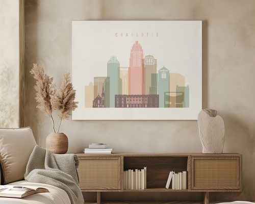 Framed artwork depicting the skyline of Charlotte with various building silhouettes and colors.