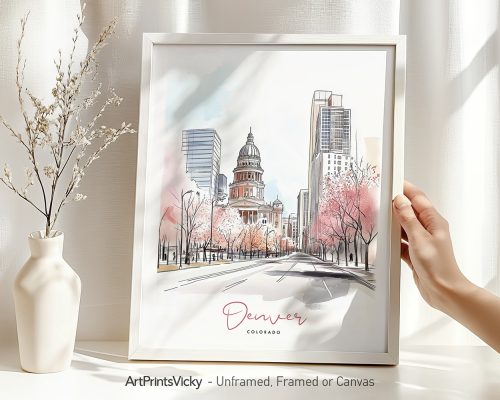 Hand holding a framed art print of Denver in watercolor drawing with soft pastel tones.