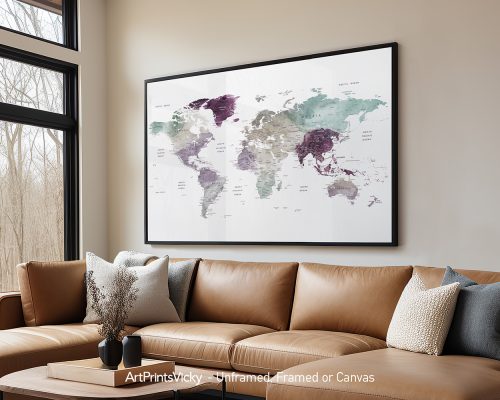 Framed world map artwork featuring various colors and geographical details on a wall above a couch.