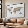 Framed world map artwork displayed on a wall above a brown leather sofa.