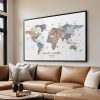 Framed world map artwork with muted colors and personalized text displayed on a wall above a couch.