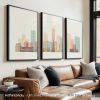 Three framed art prints of Indianapolis cityscape displayed on a wall above a sofa.