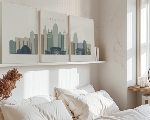 Three canvas prints of Kansas City skyline displayed above a bed with white bedding.