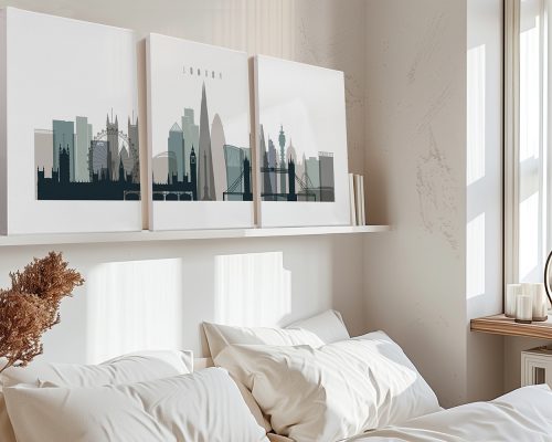 Three framed art prints of London's skyline featuring iconic landmarks on a shelf above a bed.