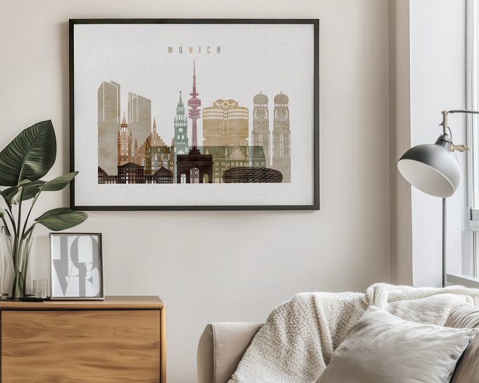 Framed artwork depicting a cityscape of Munich with notable buildings and landmarks.