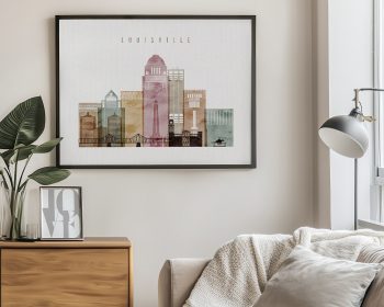 Framed artwork depicting a cityscape of Louisville with various building silhouettes in muted colors.