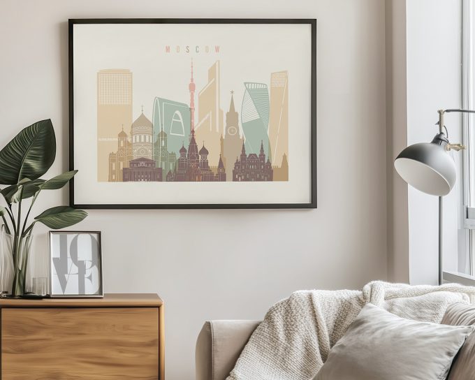 Framed artwork depicting a stylized cityscape of Moscow with notable buildings and landmarks.