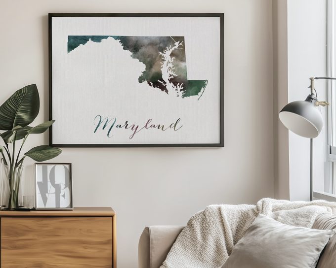 Framed artwork of the state of Maryland with a watercolor design in shades of green and blue.