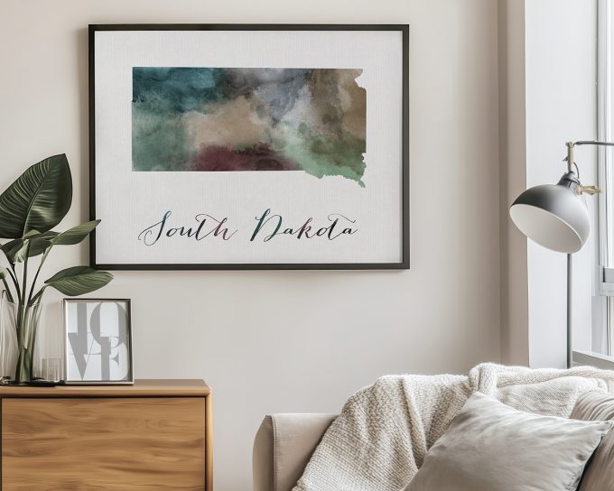 Watercolor map of South Dakota with artistic colors and the text 'South Dakota' below it.