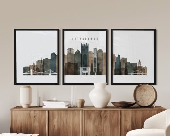 Three framed art prints depicting the skyline of Pittsburgh with notable buildings and bridges.