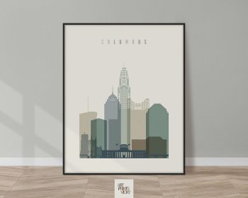 Framed artwork depicting a stylized cityscape of Columbus with various building silhouettes.