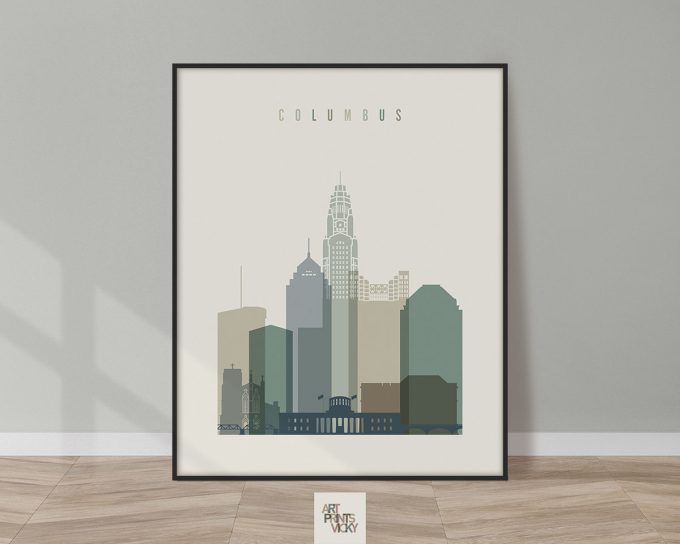 Framed artwork depicting a stylized cityscape of Columbus with various building silhouettes.
