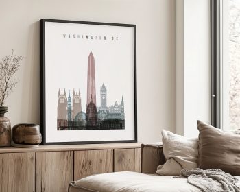 Framed cityscape print of Washington DC featuring the Washington Monument and various architectural structures.