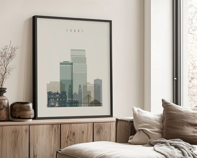 Framed artwork depicting a stylized cityscape of Omaha with various building silhouettes.