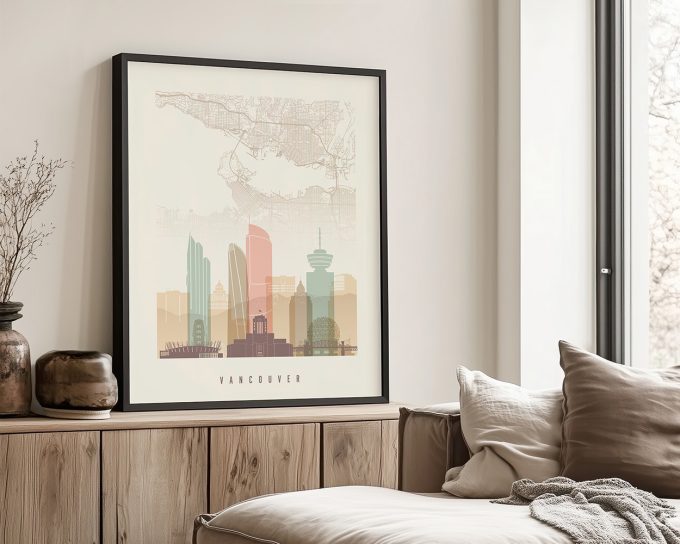 Framed artwork depicting a stylized cityscape of Vancouver with notable buildings and landmarks.