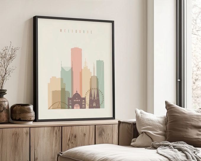 Framed artwork featuring a stylized illustration of Melbourne's skyline with notable buildings.