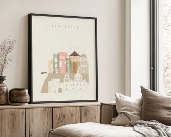 Illustration of colorful buildings and windmill in Santorini framed on a wall.
