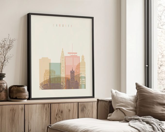Framed print of Cardiff cityscape featuring buildings in pastel colors on a light background.