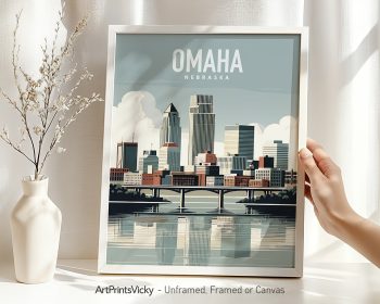 Framed cityscape print of Omaha, Nebraska, featuring buildings and a river reflection.