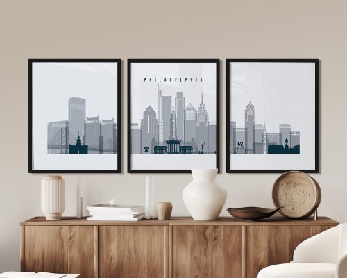 Three framed art prints depicting a stylized cityscape of Philadelphia with notable buildings.