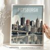 Framed print of Pittsburgh skyline featuring buildings and a bridge over water.