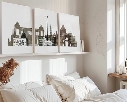 Three canvas art prints of Rome's skyline displayed above a bed in a neutral room.