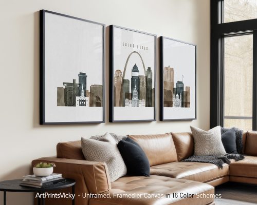 Three framed artworks depicting the Saint Louis city skyline with notable buildings and the Gateway Arch.