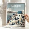 Framed art print of Santorini featuring blue domes and white buildings against a coastal backdrop.