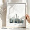 Framed map print of Seattle featuring the Space Needle and city skyline in a minimalist design.