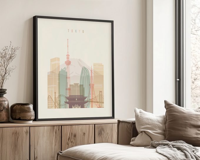 Framed artwork depicting a stylized cityscape of Tokyo with iconic landmarks and a mountain in the background.