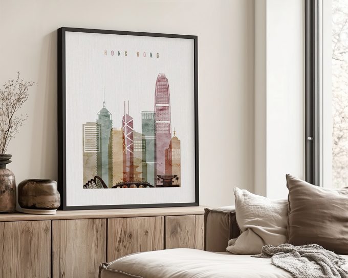 Framed artwork depicting a stylized cityscape of Hong Kong with various skyscrapers and buildings.