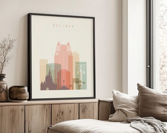 Framed art print of a stylized Orlando cityscape with pastel colors and prominent buildings.