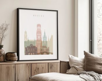 Framed artwork depicting a cityscape of Bruges with various architectural styles in pastel colors.
