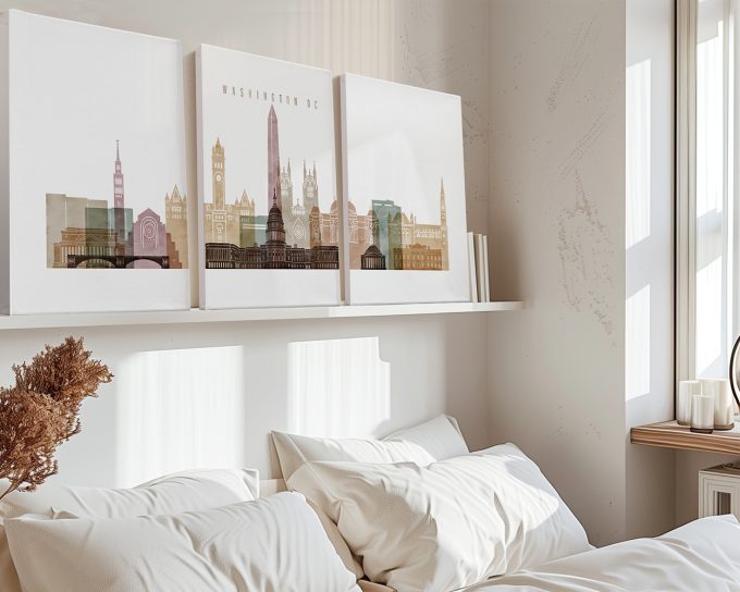 Three canvas prints depicting a stylized cityscape of Washington DC on a shelf above a bed.