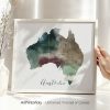 Watercolor map of Australia with soft colors and outlined states, displayed in a frame.