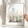 Framed artwork depicting a stylized cityscape of Beijing with notable buildings and structures.