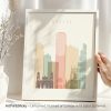 Art print of a stylized cityscape of Bogota featuring buildings in pastel colors.