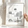 Black and white outline illustration of Boston's skyline in a framed print.