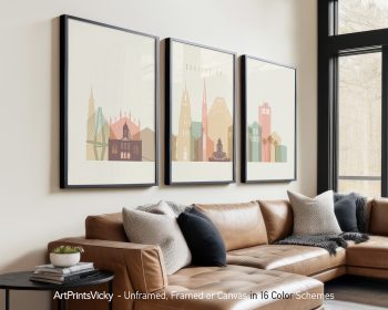 Three framed art prints depicting a stylized cityscape of Charleston with various buildings.