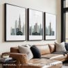 Three framed art prints depicting a stylized cityscape of Chicago in muted colors.