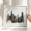Framed artwork depicting a stylized skyline of Chicago with notable buildings.