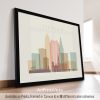 Framed artwork depicting a stylized cityscape of Cleveland with skyscrapers and a bridge.