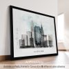 Framed artwork depicting a watercolor cityscape of Cleveland with a bridge and skyline.