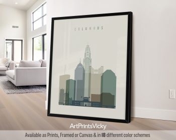 Framed artwork depicting a stylized cityscape of Columbus with various building silhouettes.