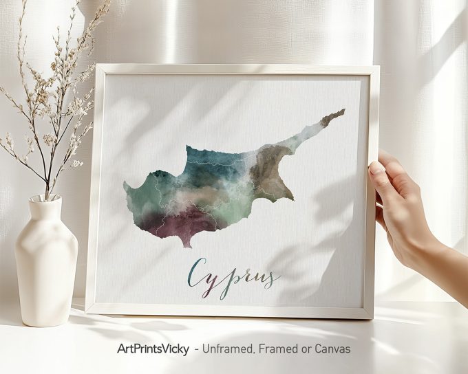 Watercolor map of Cyprus displayed in a frame with a hand holding it.